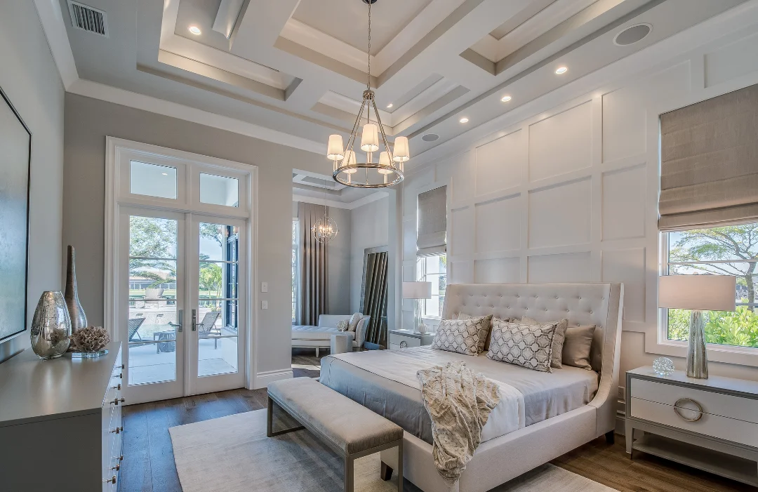 Luxurious master suite with designer tray ceilings, French doors to the private patio, hard wood floors and modern accents