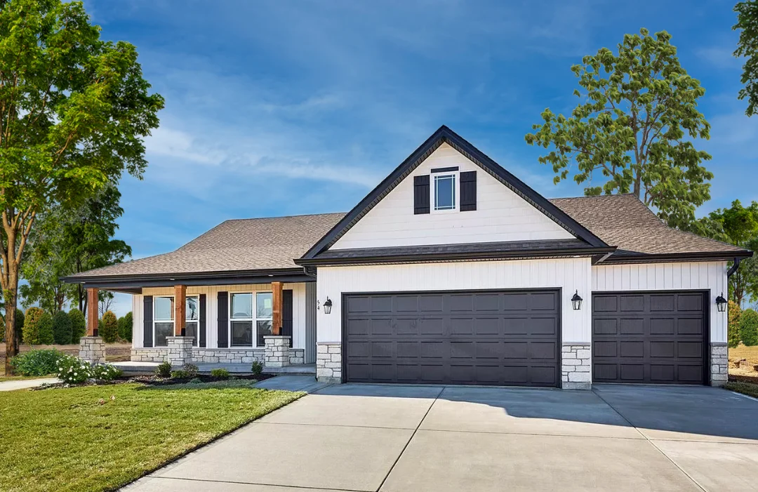 A CMS home with a peaked roof, cream siding, stone trim and a 3-pillar porch. Lots of green grass and trees in the yard.