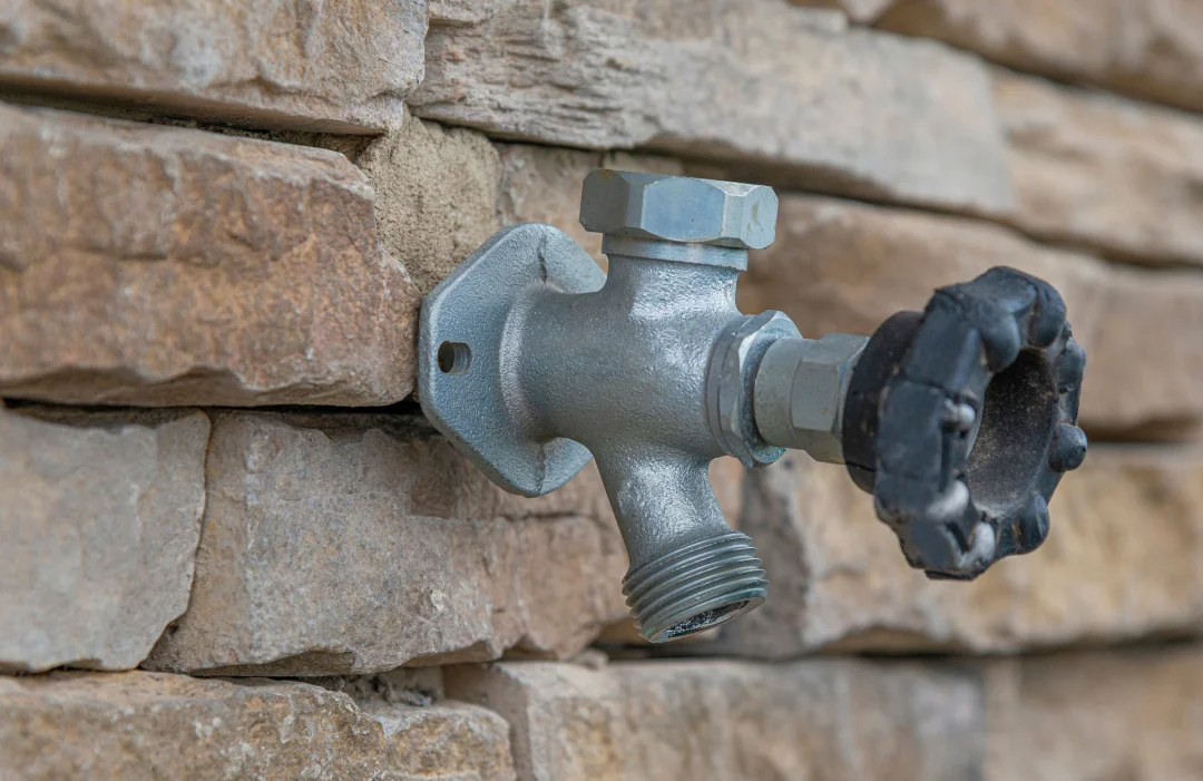 Water spigot in a stone wall